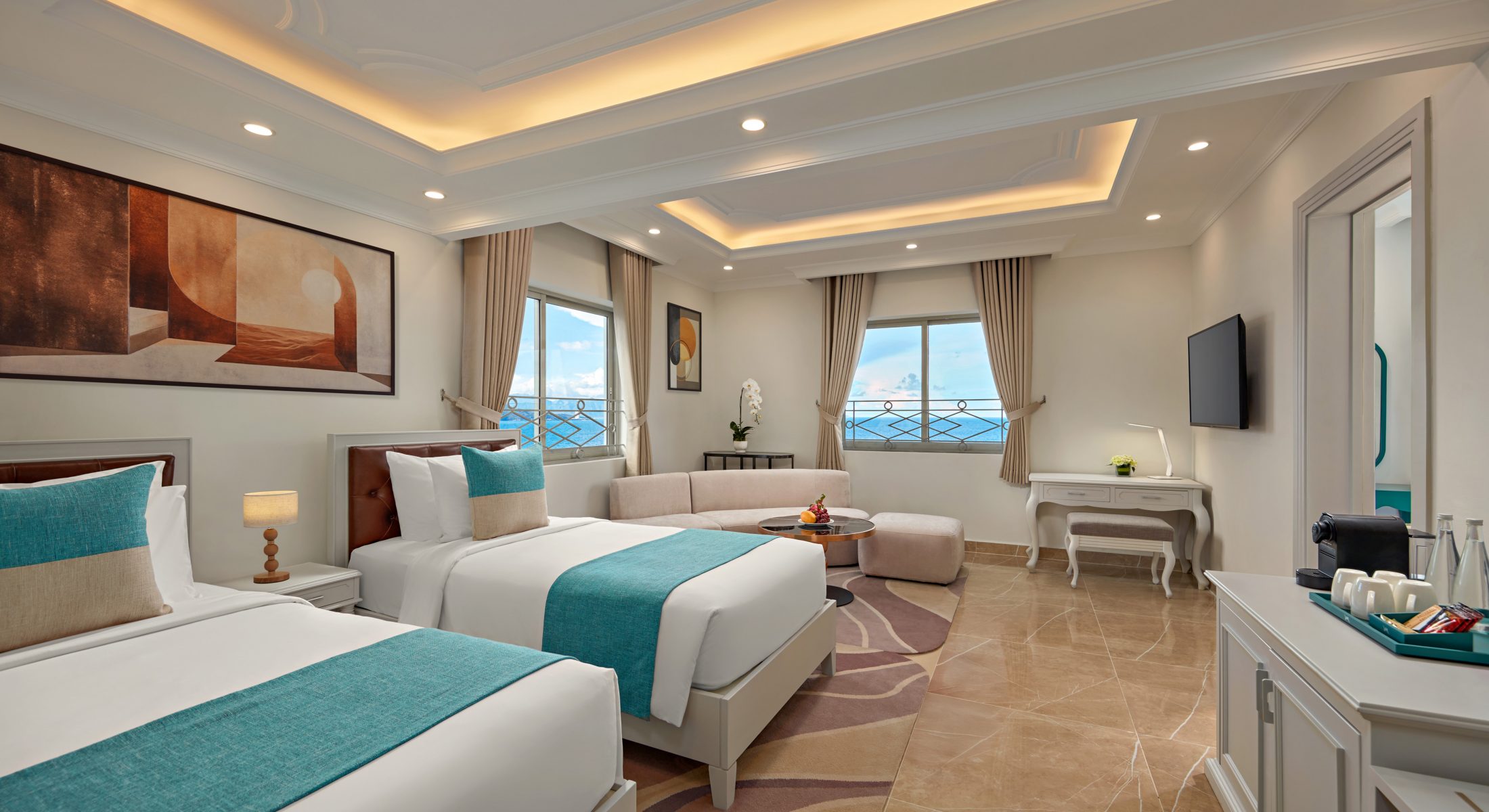 Family Suite with twin beds, sofa area and sea view at Mercure Nha Trang Beach Hotel