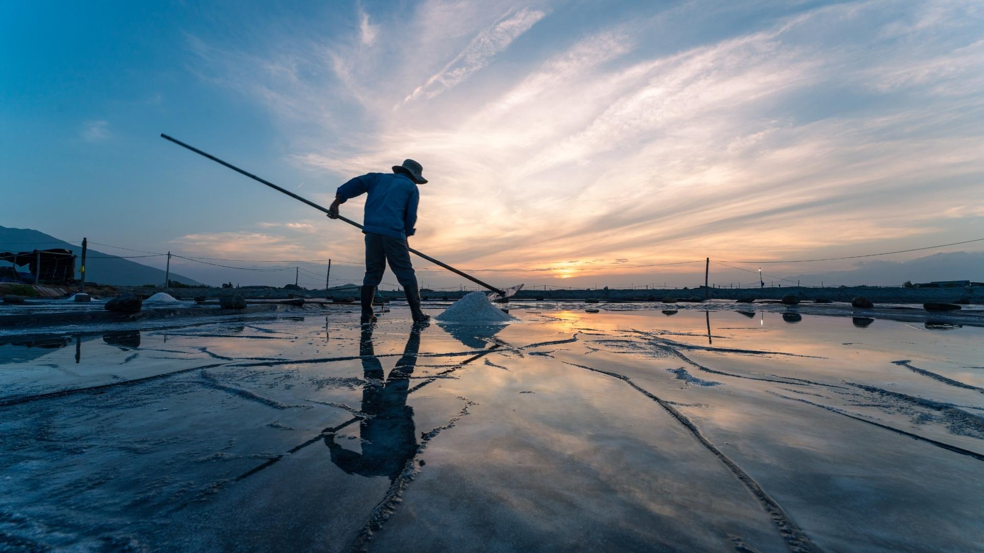 Collecting salt on Hon Khoi salt field in nha trang
